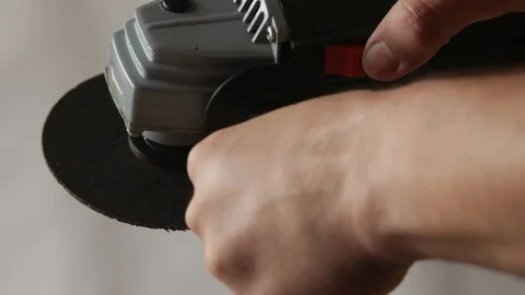 Turning on a hand angle grinder Stock Footage 97641270