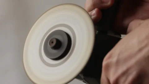 Turning on a hand disc grinder Stock Footage 97641204