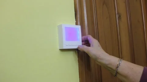 Turning the heating thermostat on Stock Footage 322026885