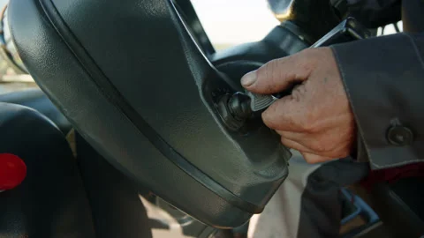 Turning key in ignition of tractor or combine. Running agricultural machinery in Stock Footage 222851297