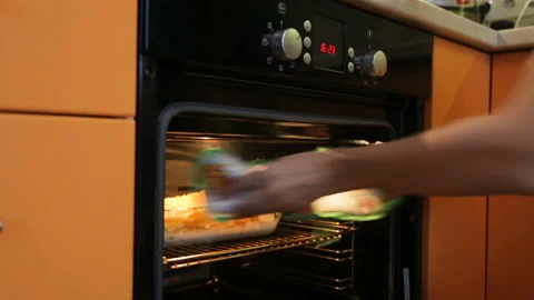 Turning on kitchen oven Video stock 102845122