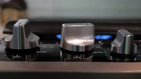 Turning knob, opening gas on a kitchen stove. close Up. Stockbeeldmateriaal 206598628