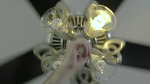 Turning the light on and off via the pull cord on a Ceiling fan light Stock Footage 63213454