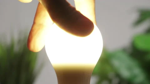 Turning on a light bulb by screwing it in. Stock Footage 194012727
