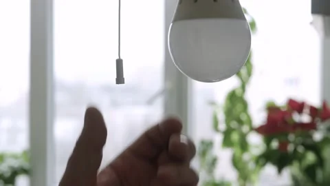  Turning on the Light in a Room Using a Switch and a LED Bulb..  Stock-Footage 164432701