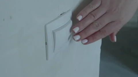 Turning the light switch on and off Stock Footage 132495607