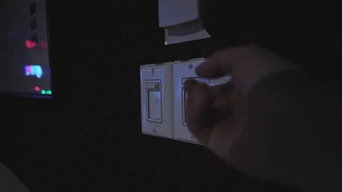 Turning on a light switches in a studio 库存影片 89580488