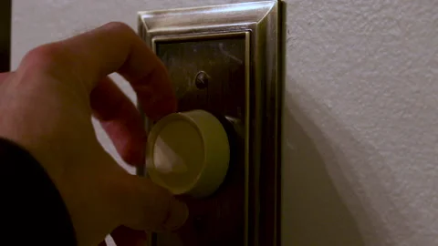 Turning on the Lights with a Dimmer Stock Footage 153490694