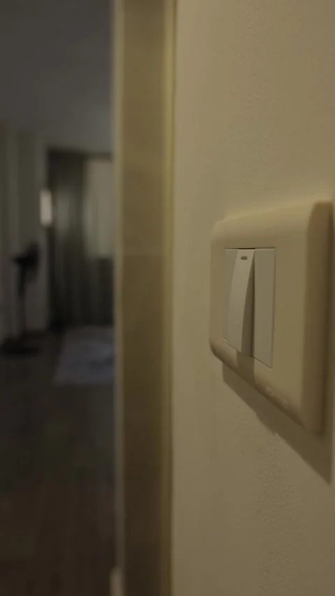 Turning off lights at home, close up of hand pressing wall light switch to save Stock Footage 346243276