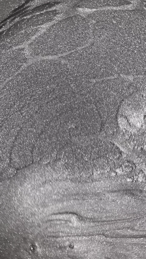 Turning macro shot of dark titanium paint specialized sandy texture and radiant Stock Footage 327605314