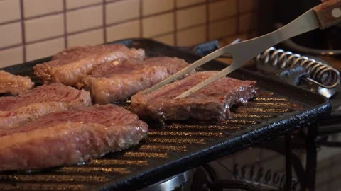 Turning meat on the grill Stock Footage 130267540