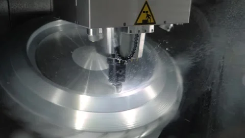 Turning milling machine with cooling system cutting metal workpiece at factory Stock Footage 140231649