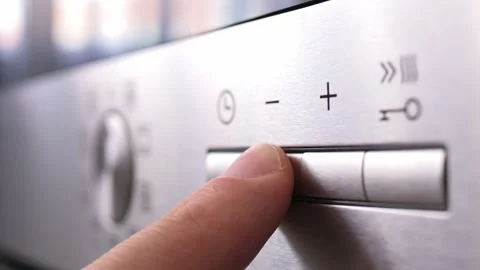 Turning on the mode switch and setting the time on electric oven. Male hand Stock Footage 204900213