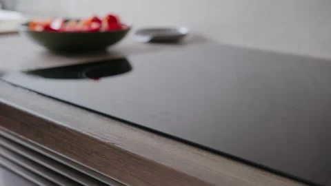 Turning on Modern Induction Cooktop and Placing Frying Pan Stock Footage 345834728