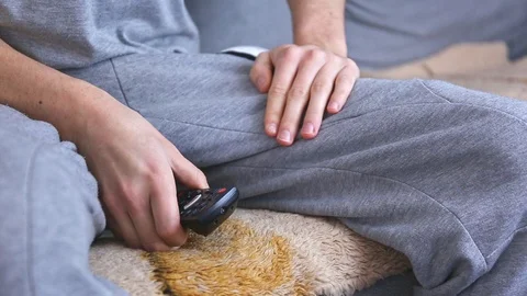 Turning on the Netflix application on a TV pilot at home by a young man Stock Footage 128955737