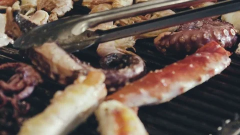 Turning octopus on the grill  Video stock 70738762