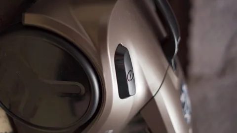 Turning on the operation button of a bagless modern vacuum cleaner, close-up Stock Footage 262634853