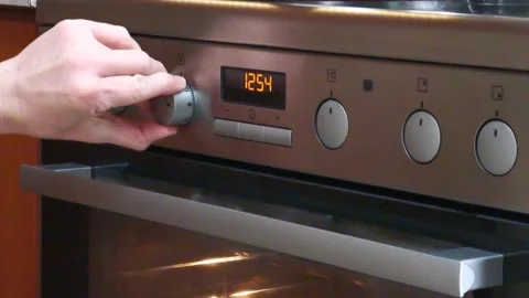 Turning the oven on Stock Footage 143742727