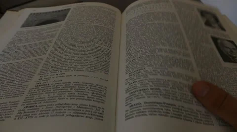 Turning Over The Page In The Book - Encyclopedia - Old Books Stock Footage 49043223