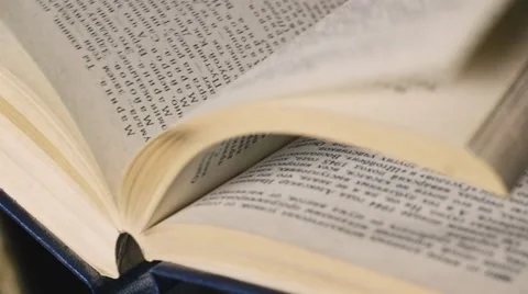 Turning over Pages of a Book in Library Stock Footage