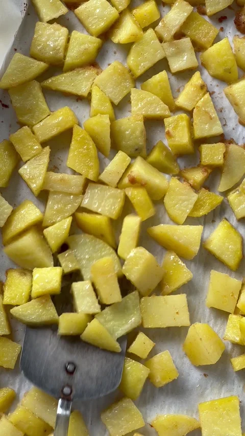 Turning over potato cubes vertical Stock Footage 219512425