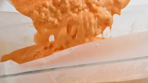 Turning over the pudding to bake it Stock Footage 228220727
