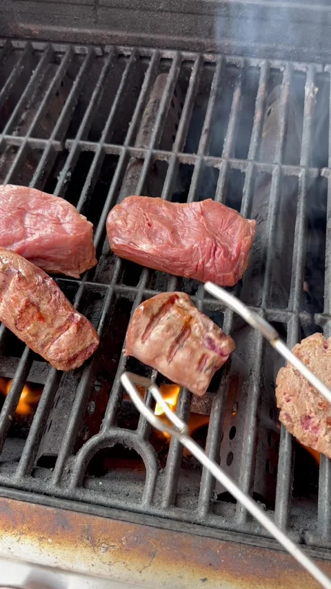 Turning Over Steaks On A Grill, Vertical Stock-Footage 250562958