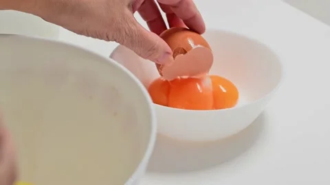 Turning over the yolk of eggs Stock Footage 228220530