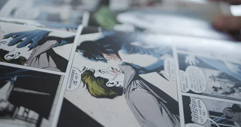 Turning pages of a comic book Stockbeeldmateriaal 128615910