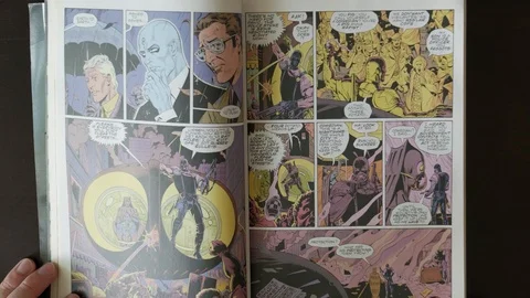 Turning pages of comic book Watchmen - reading great graphic novel Stockbeeldmateriaal 92525656