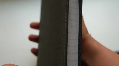 Turning pages in a gray notebook Stock Footage 68908745