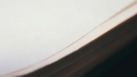 Turning the pages of an old book close-up Stock Footage