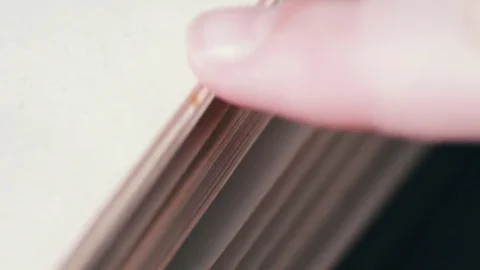 Turning the pages of an old book close-up Stock Footage
