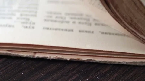 Turning the pages of an old book close-up Stock Footage