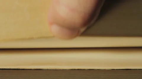 Turning the pages of an old book Stock Footage 54602714