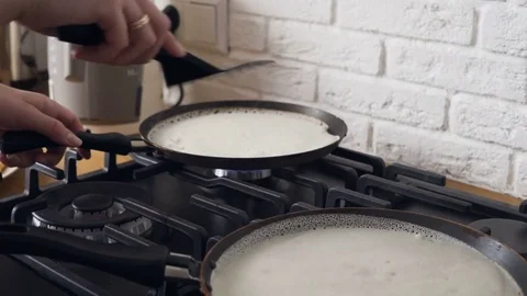 Turning pancakes on two pans Video stock 72205233