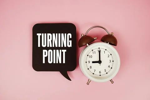 Turning Point text on speech bubble with alarm clock on pink background Stock Photos
