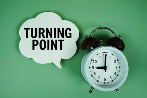 Turning Point text on speech bubble with alarm clock on green background Stock Photos