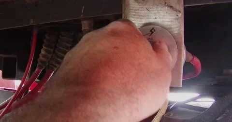 Turning off power on a large farm tractor at the battery disconnect Stock Footage 172520735