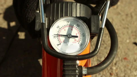 Turning on the pump attached to a car wheel Stock Footage 130648852