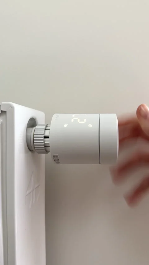 Turning on radiator heating system using thermostatic valve control knob du.. Stock-Footage 346156852