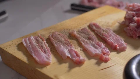Turning the raw bacon into spices Stock-Footage 111272763