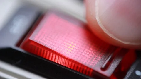 Turning on/off red switch button closeup 動画素材 86056111