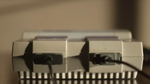 Turning on Retro Game Console and inserting game in slow motion, 4k Stock Footage 120261393