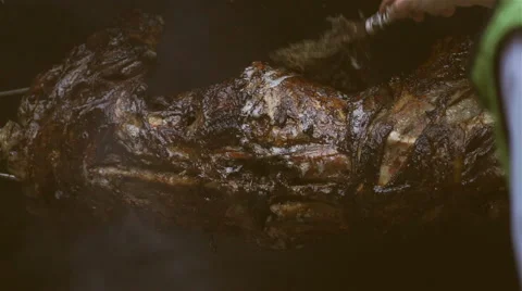 Turning roasted lamb Stock Footage 61740150