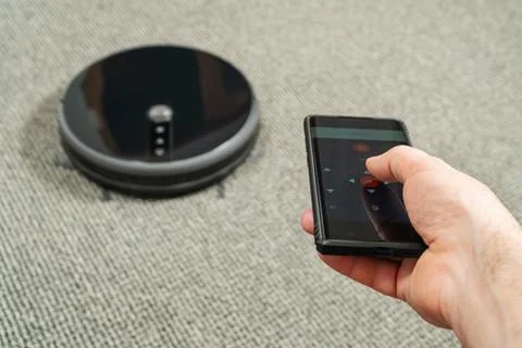Turning on the robot cleaner Stock Photos