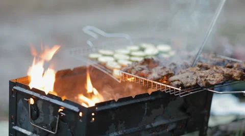 Turning round meat on the BBQ grill Stock Footage 51859145