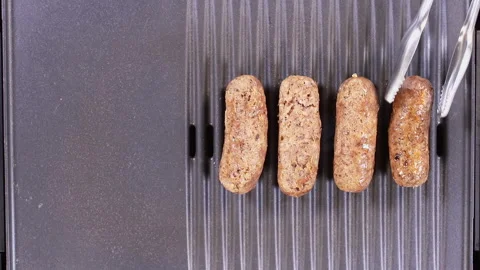 Turning Sausages On a Grill Stock Footage 248743933