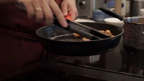Turning seafood over in pan Stock Footage 112127212
