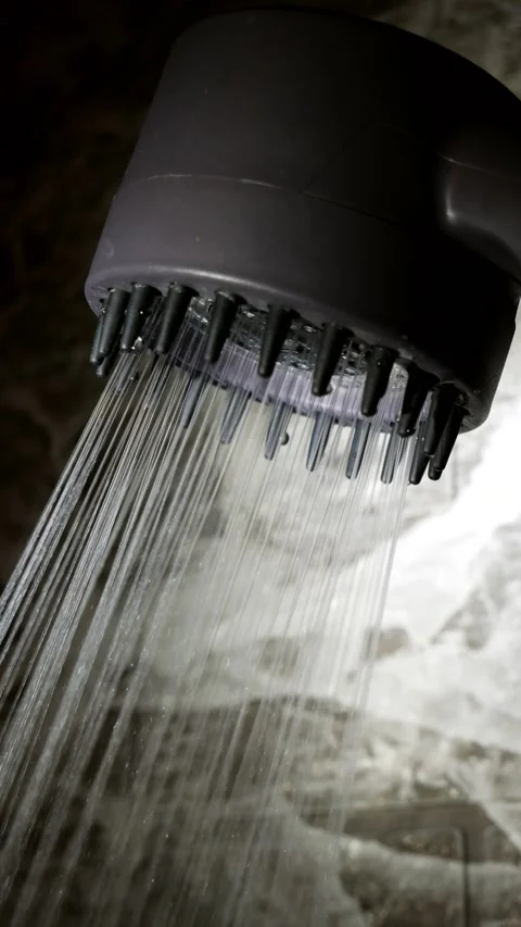 Turning the shower head on and off in the bathroom. Clear water flows from the Stock Footage 330496149